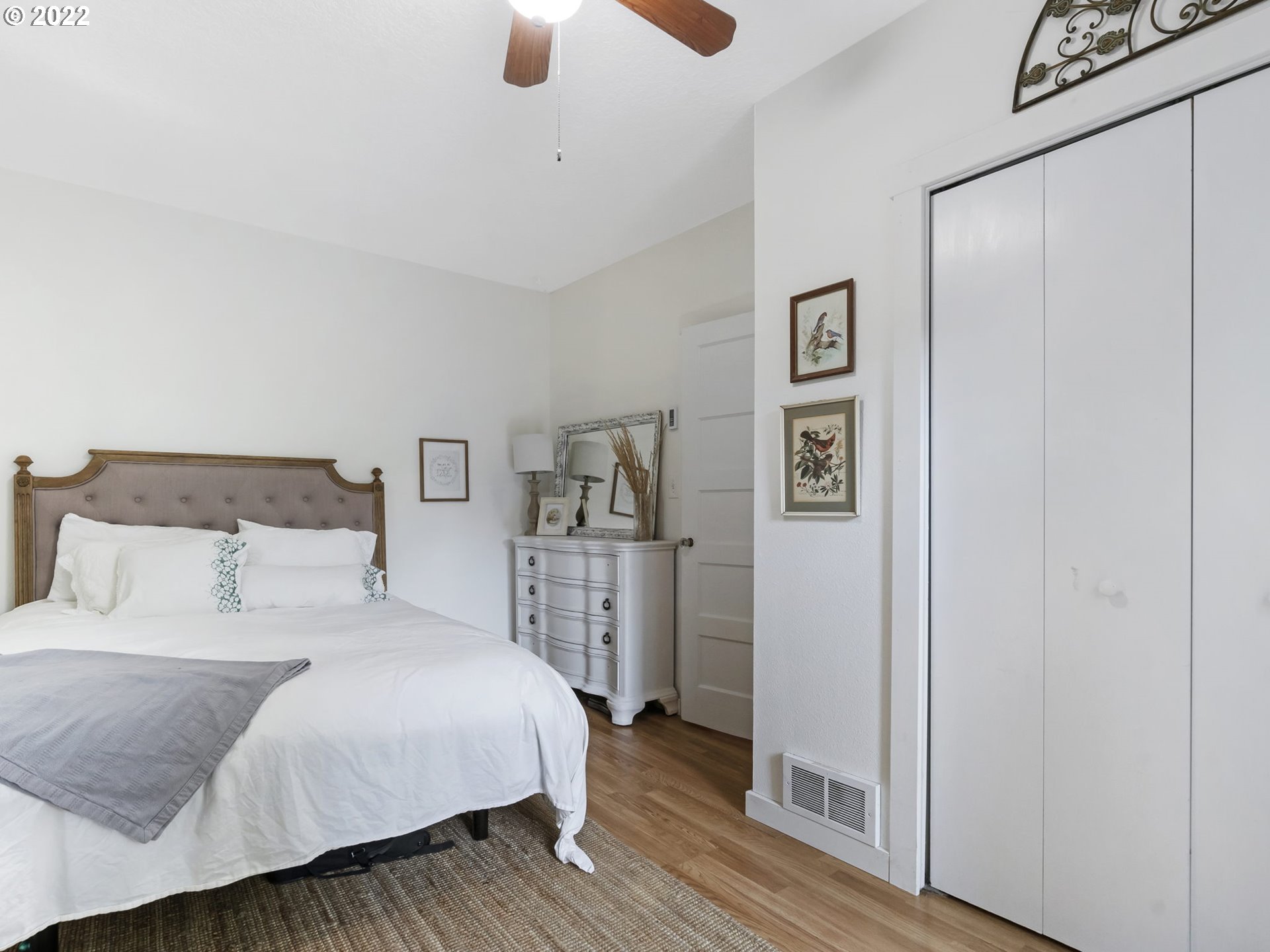 1689 Southwest Stringtown Road Forest Grove, OR 97116 - Photo 18 of 28 a bedroom with a large bed and a chandelier