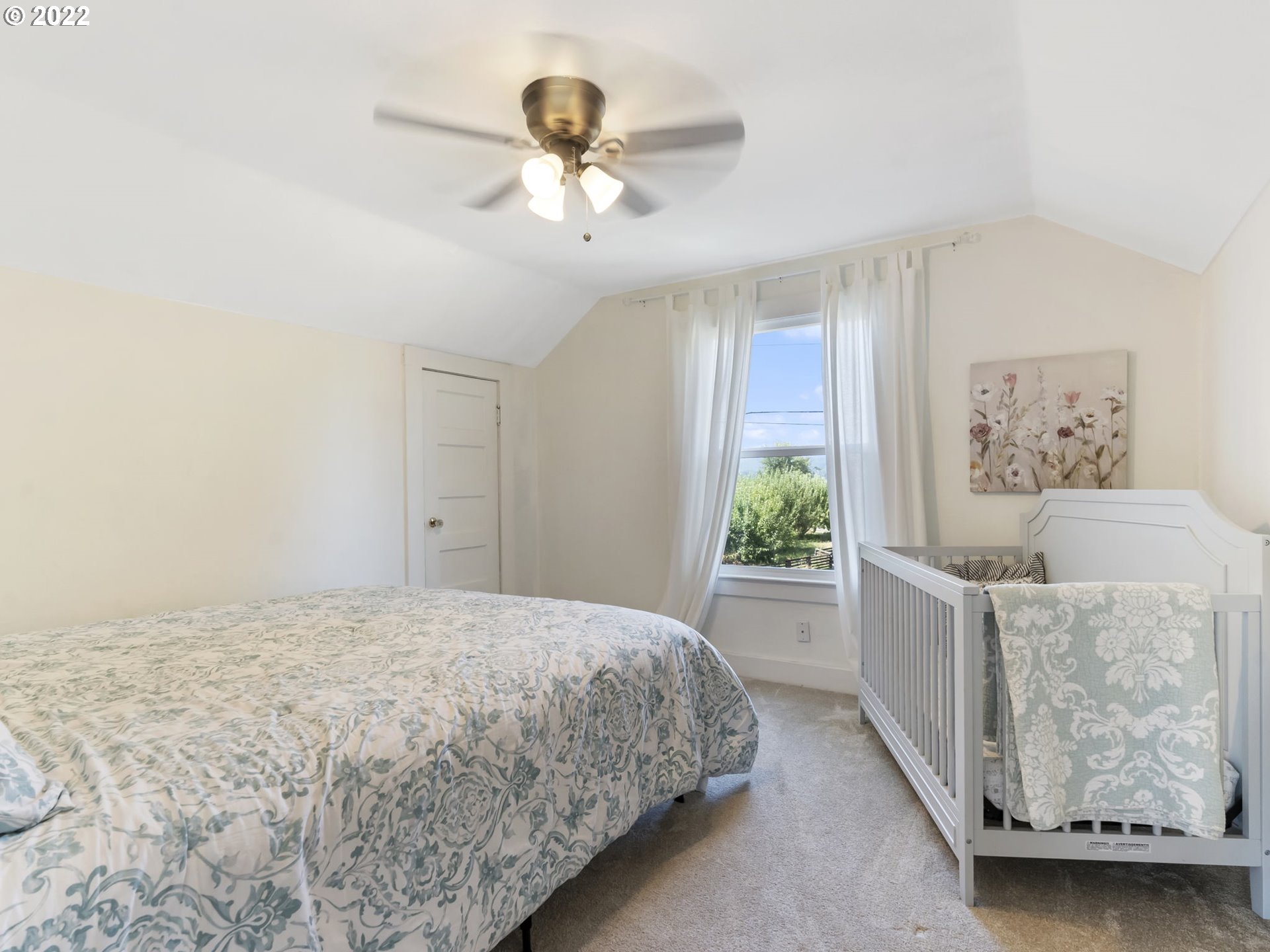 1689 Southwest Stringtown Road Forest Grove, OR 97116 - Photo 21 of 28 a bedroom with a bed and a chandelier
