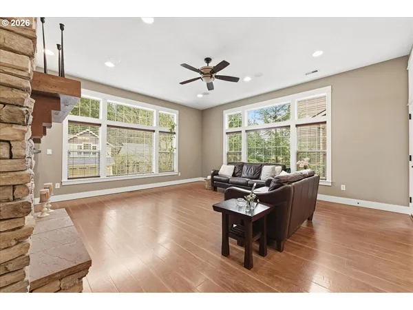 a living room with furniture and large windows