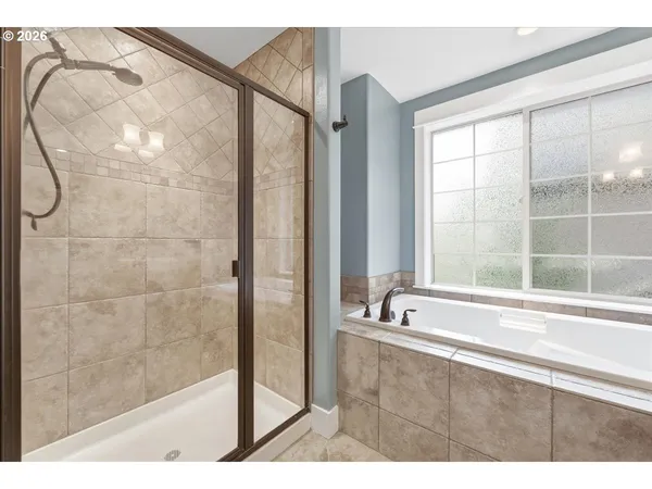 a bathroom with a bathtub and a shower
