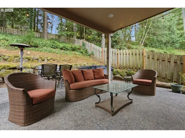 a view of a backyard with plants and outdoor seating