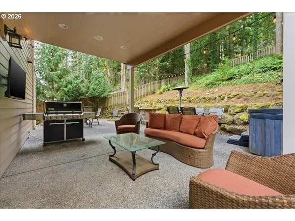 a view of a backyard with table and chairs and couches