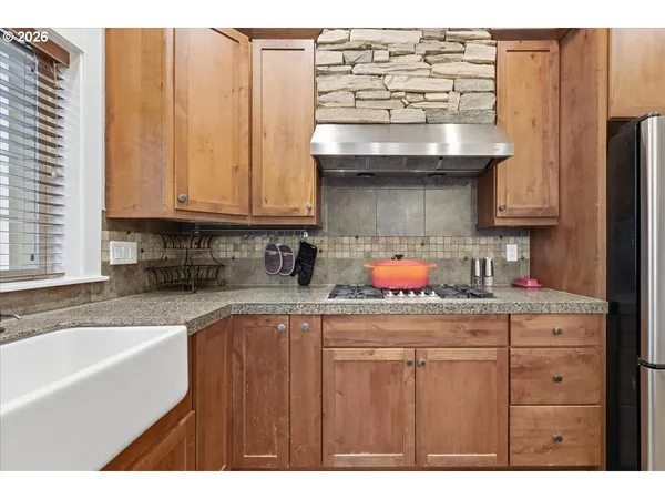 a kitchen with stainless steel appliances granite countertop a sink and cabinets