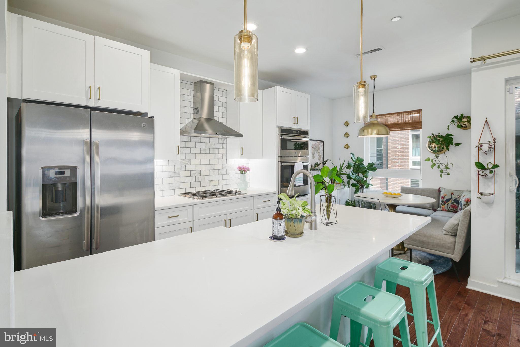 159 East Allen Street, Unit 1 Philadelphia, PA 19125 - Photo 13 of 45 a kitchen with kitchen island white cabinets and stainless steel appliances