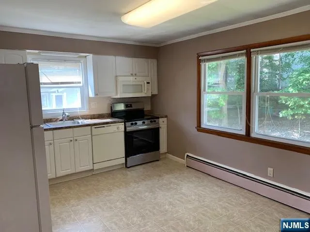 a kitchen with a stove a sink and a window