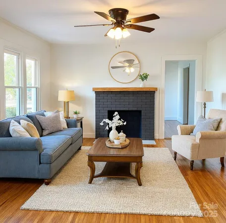a living room with furniture a rug and a fireplace