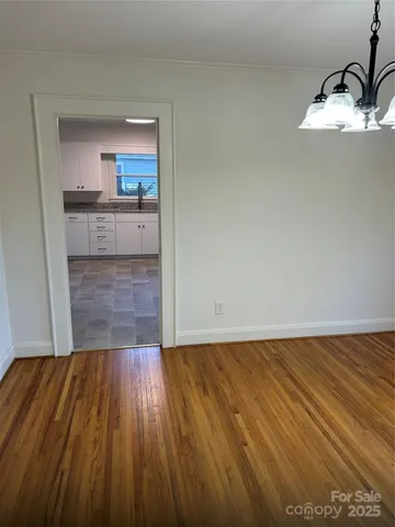 a view of a kitchen with wooden floor and a sink