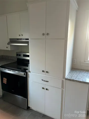 a stove top oven sitting inside of a kitchen