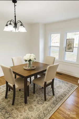 a view of a dining room with a table and chairs