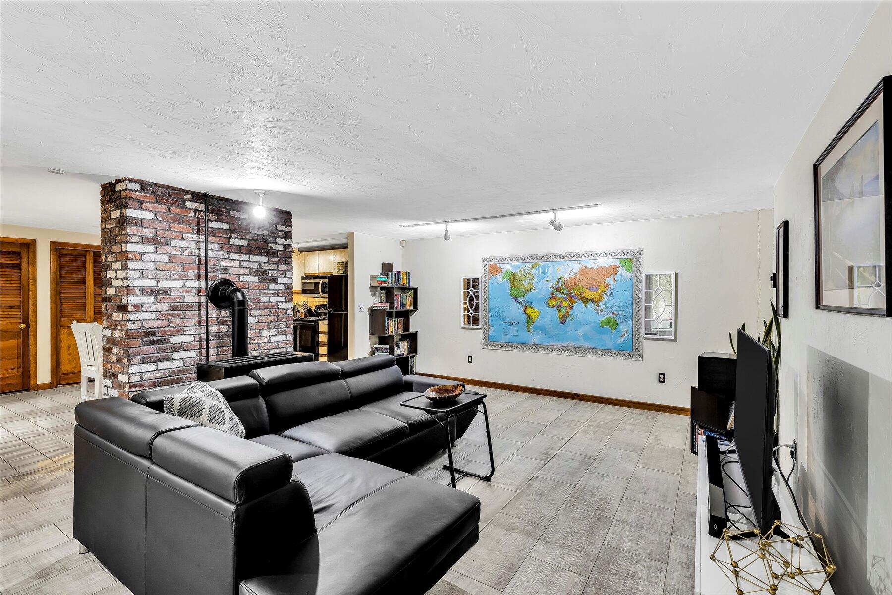 1007 River Road Marstons Mills, MA 02648 - Photo 17 of 33 a living room with fireplace furniture and a flat screen tv