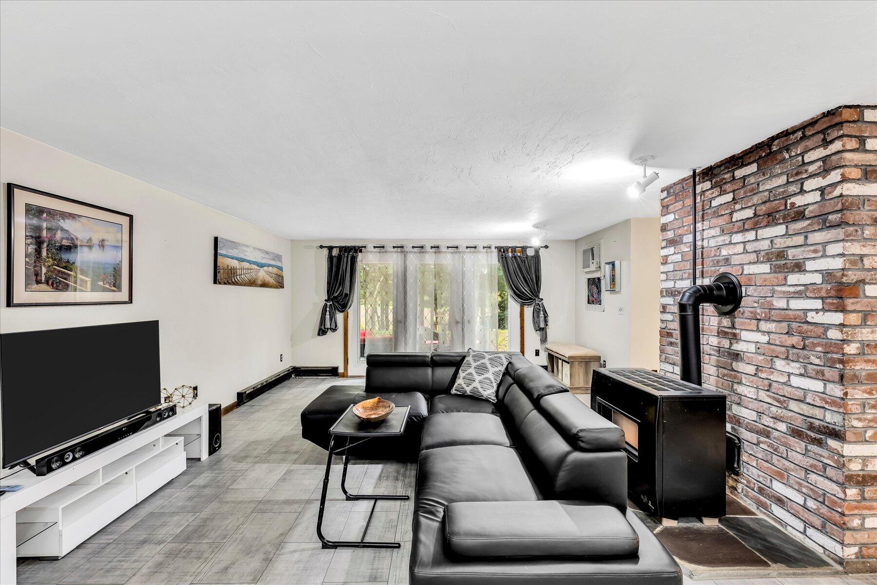 1007 River Road Marstons Mills, MA 02648 - Photo 18 of 33 a living room with furniture and a flat screen tv