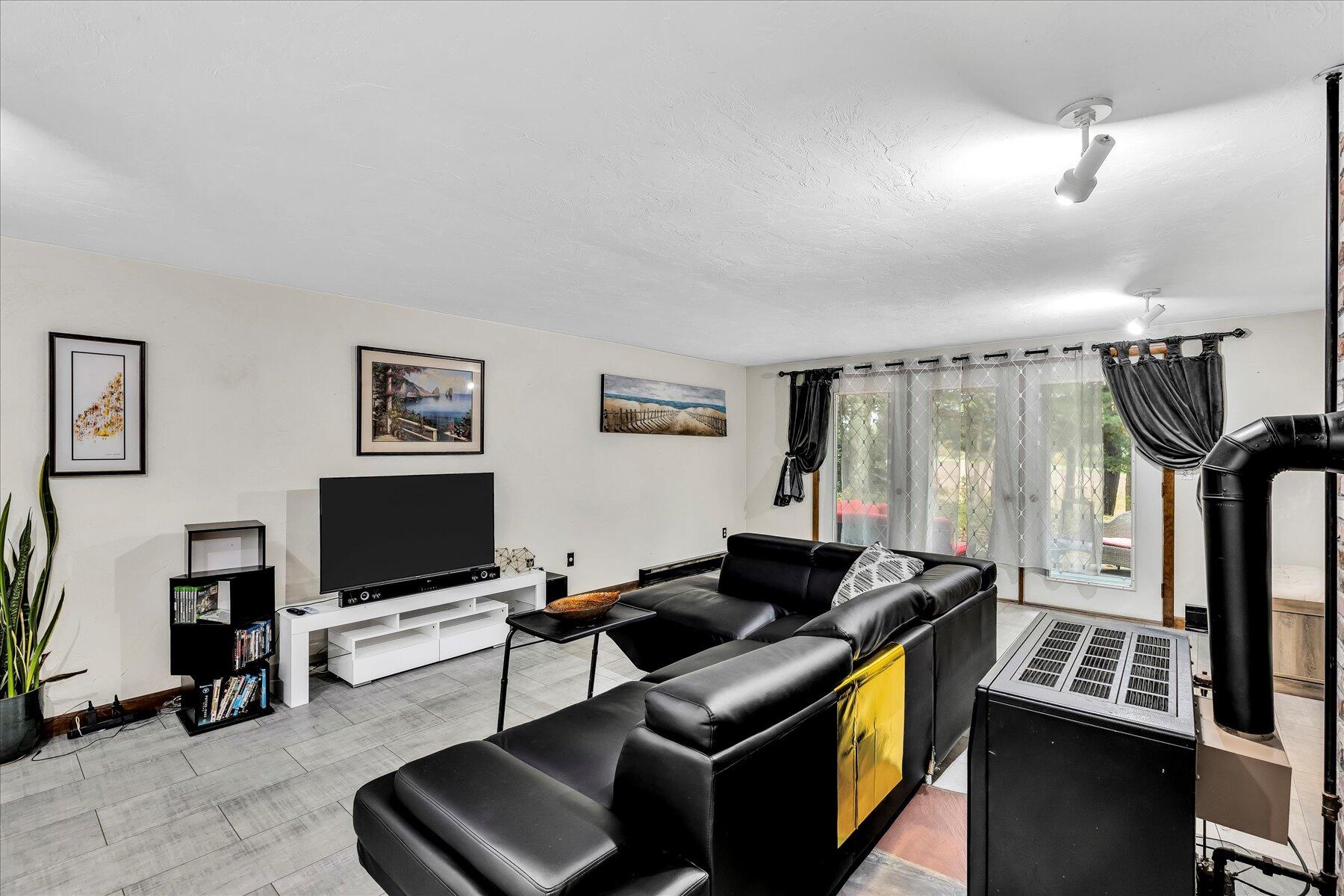 1007 River Road Marstons Mills, MA 02648 - Photo 19 of 33 a work room with furniture and a flat screen tv