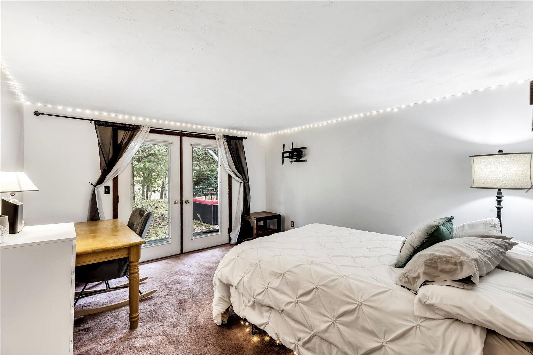 1007 River Road Marstons Mills, MA 02648 - Photo 21 of 33 a bedroom with a large bed and a large window with outer view