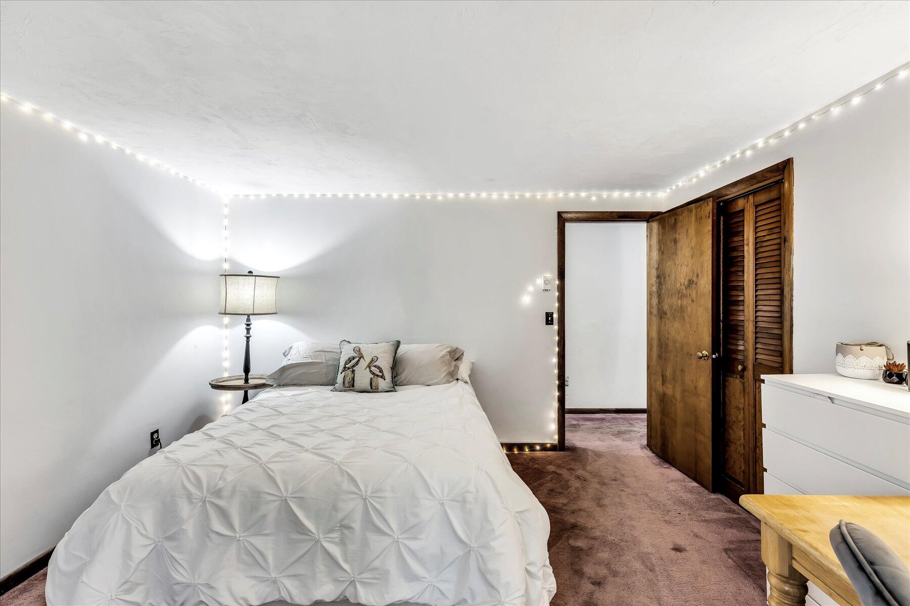 1007 River Road Marstons Mills, MA 02648 - Photo 23 of 33 a bedroom with a bed and a lamp