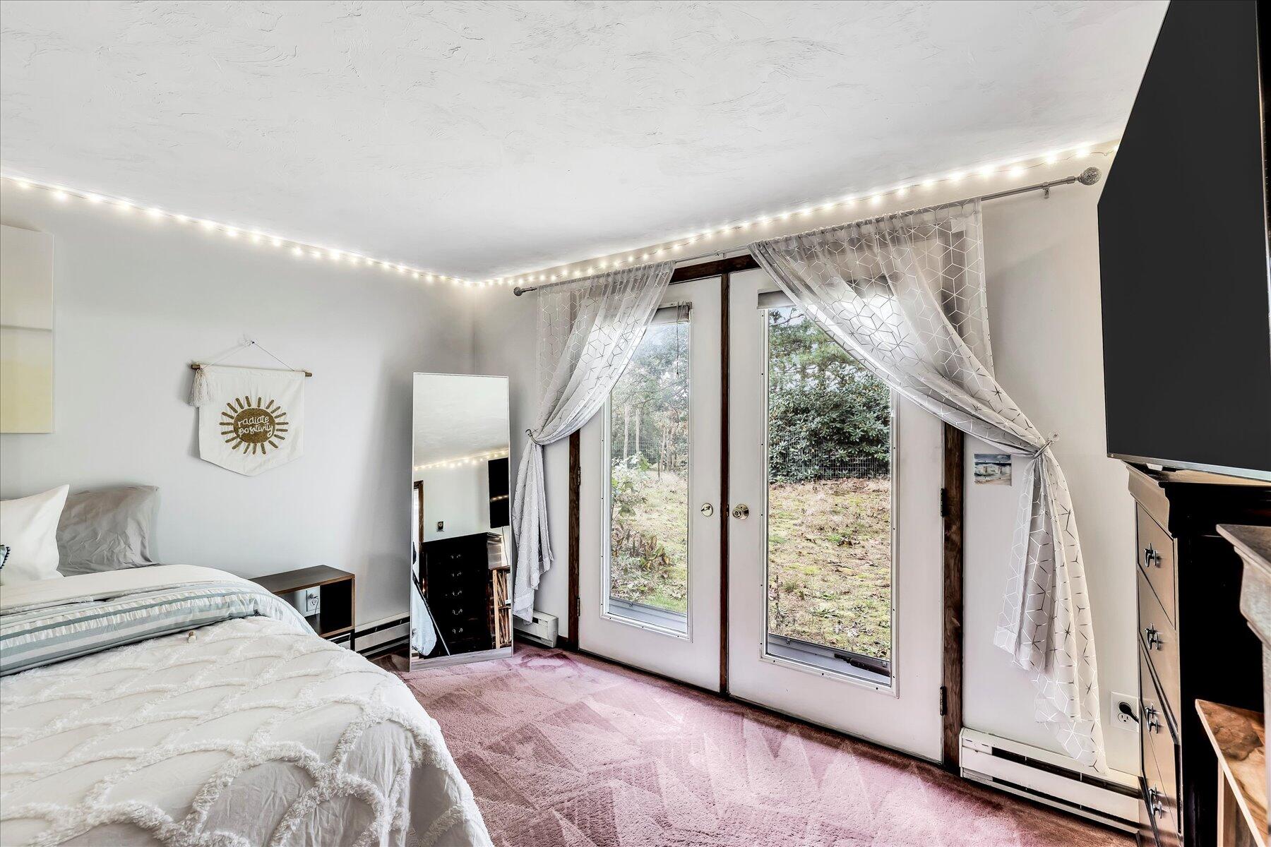 1007 River Road Marstons Mills, MA 02648 - Photo 27 of 33 a bedroom with a large window and walk in closet