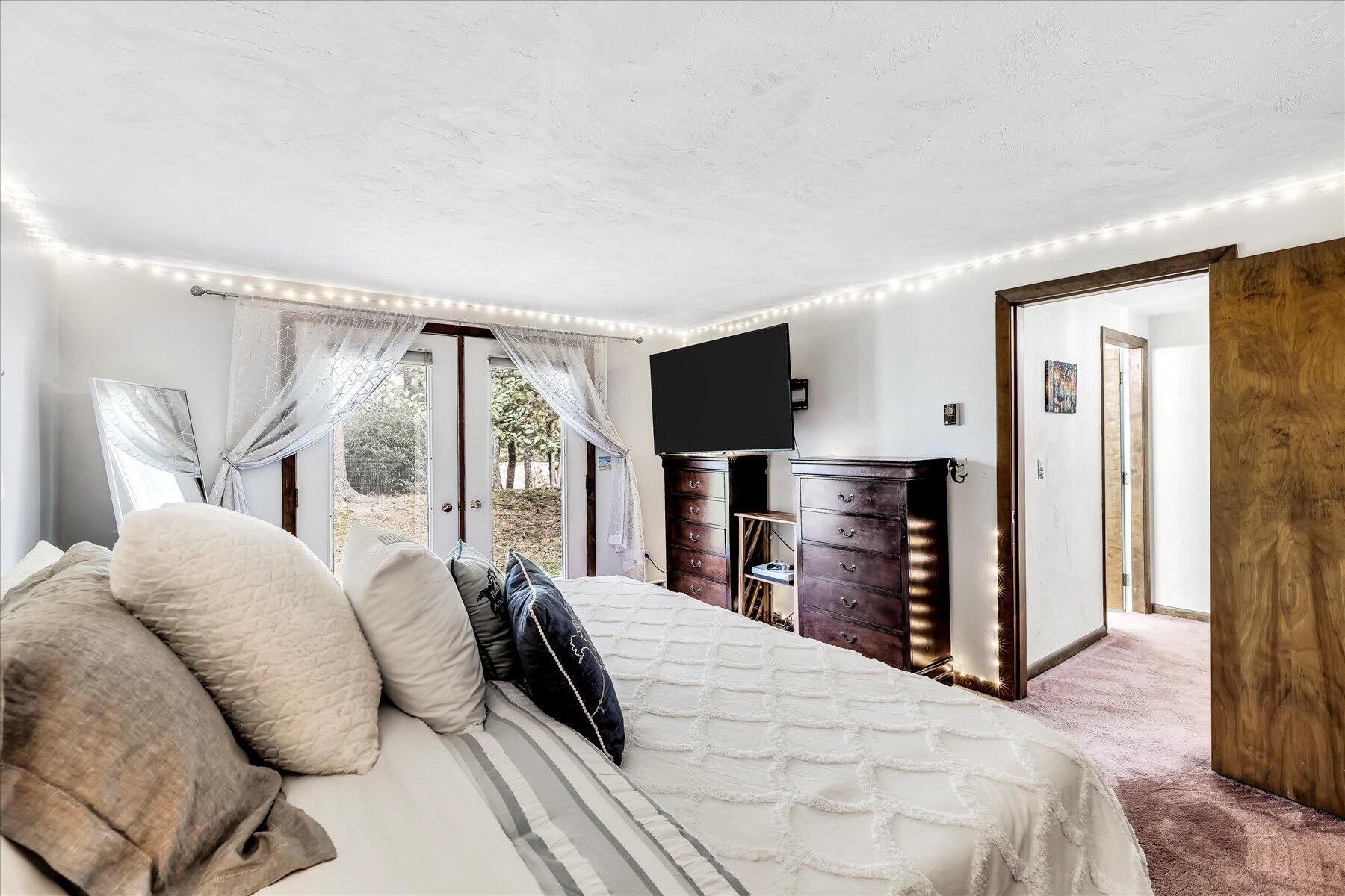 1007 River Road Marstons Mills, MA 02648 - Photo 28 of 33 a bedroom with a bed and a flat tv screen