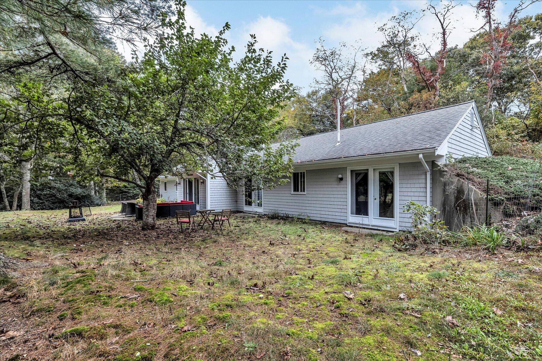 1007 River Road Marstons Mills, MA 02648 - Photo 31 of 33 a view of a house with a tree next to a yard