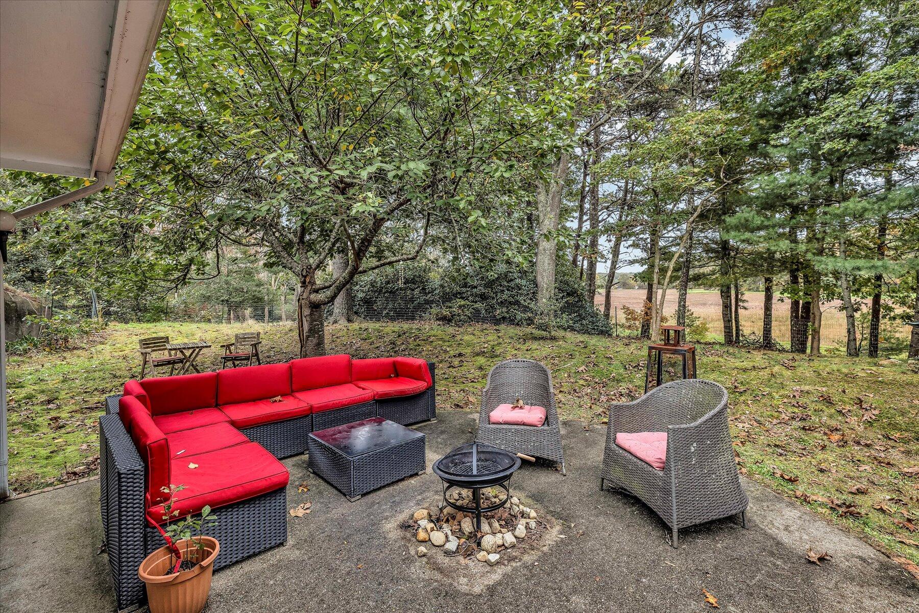 1007 River Road Marstons Mills, MA 02648 - Photo 32 of 33 a backyard of a house with outdoor seating