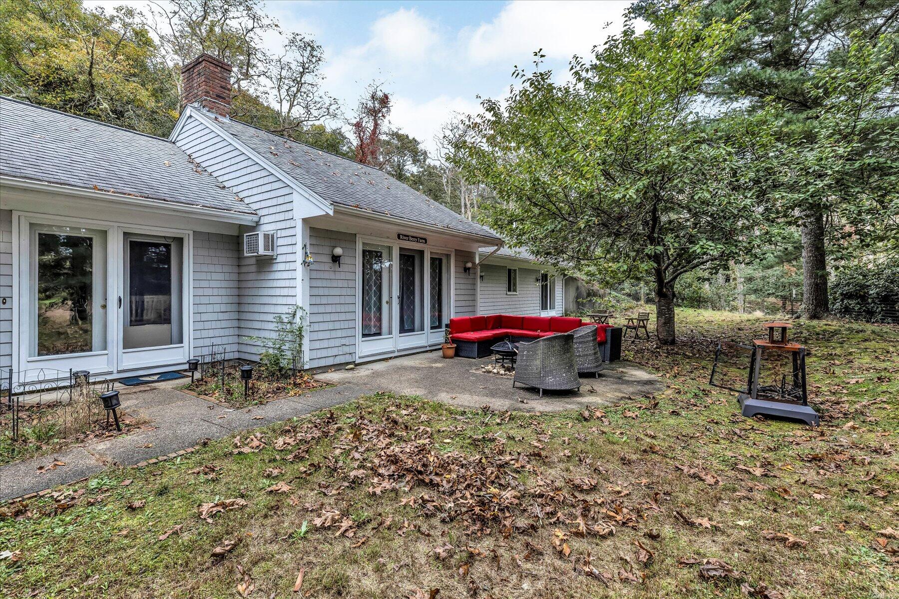 1007 River Road Marstons Mills, MA 02648 - Photo 6 of 33 a view of a house with a yard and sitting area