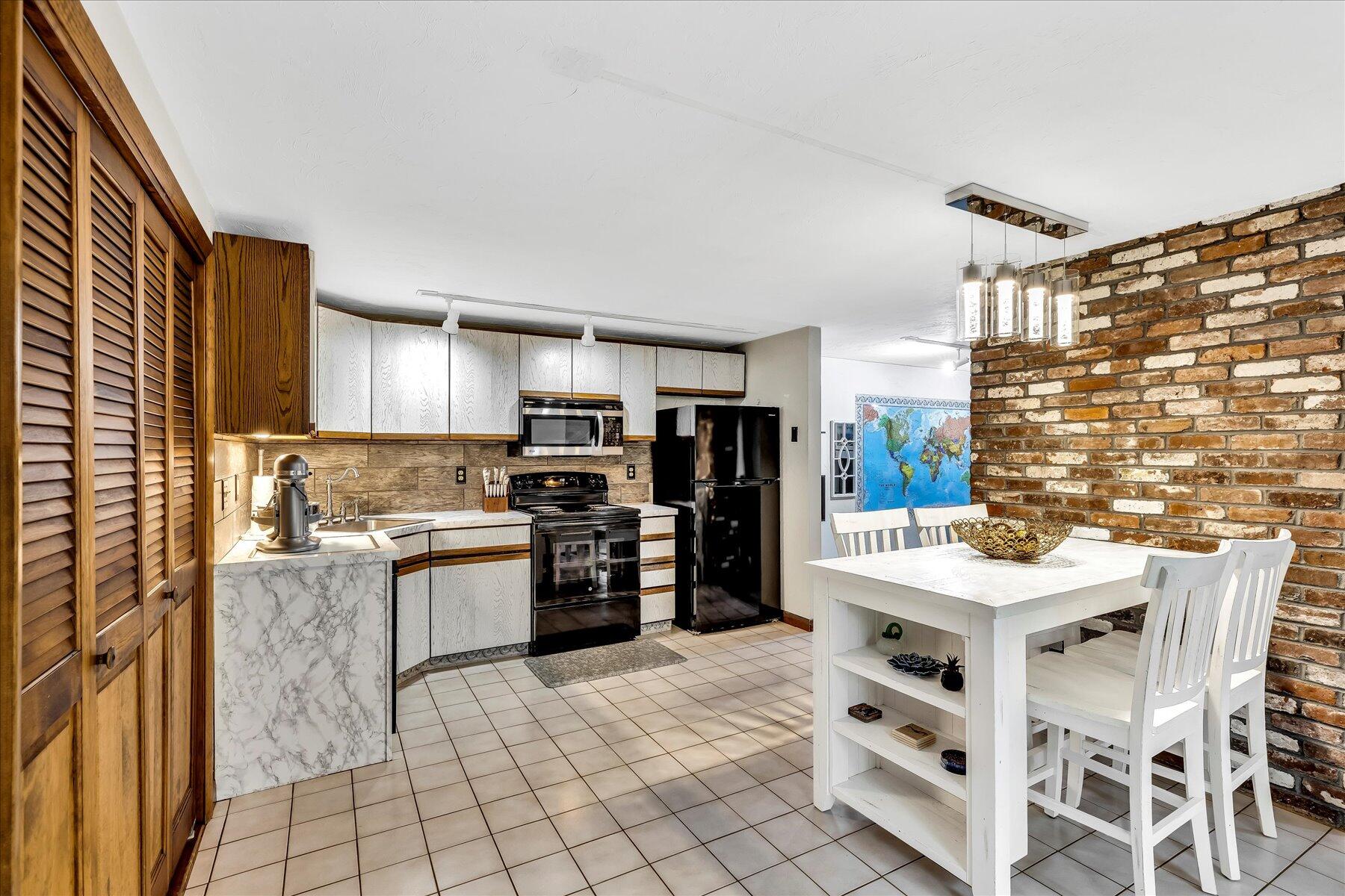 1007 River Road Marstons Mills, MA 02648 - Photo 7 of 33 a kitchen with stainless steel appliances kitchen island granite countertop a refrigerator and a stove top oven