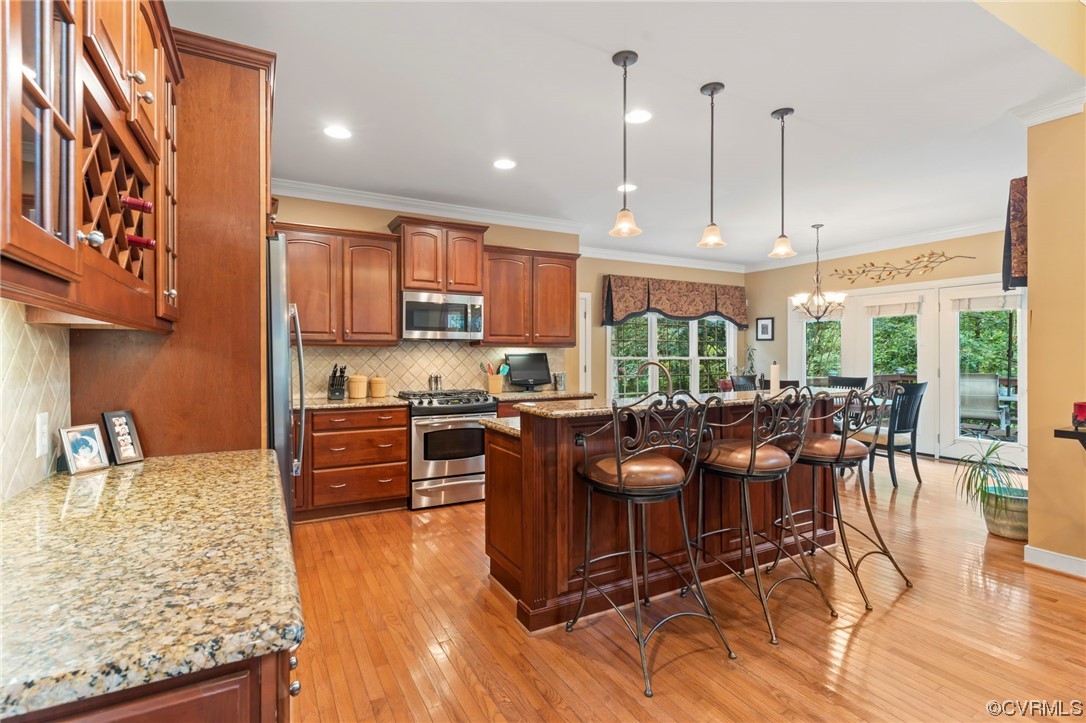 13206 Tipple Point Road Midlothian, VA 23114 - Photo 4 of 50 a kitchen with stainless steel appliances granite countertop a stove top oven a sink a dining table and chairs with wooden floor