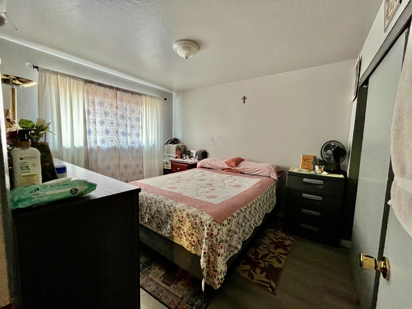 128 Maple Avenue Watsonville, CA 95076 - Photo 18 of 29 a bed sitting in a bedroom next to a window