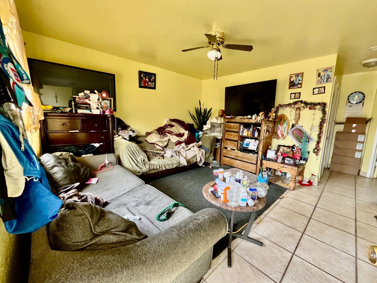 128 Maple Avenue Watsonville, CA 95076 - Photo 19 of 29 a living room with furniture and a flat screen tv