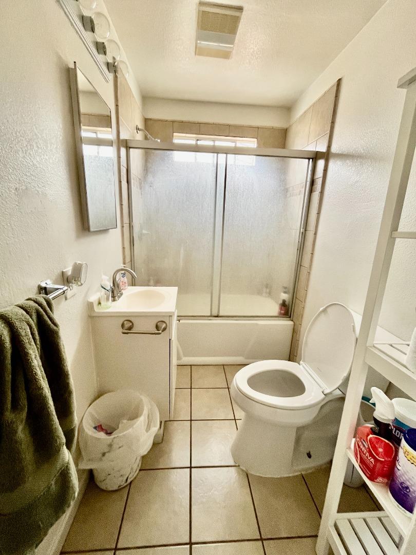 128 Maple Avenue Watsonville, CA 95076 - Photo 28 of 29 a bathroom with a toilet sink and mirror