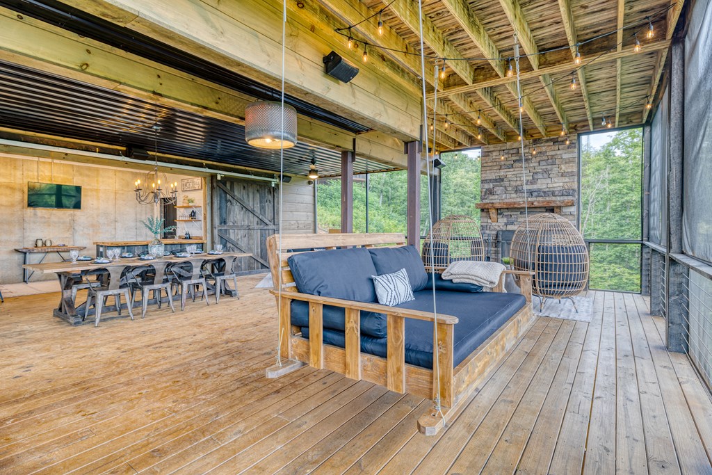 190 Firefly Road Blue Ridge, GA 30513 - Photo 42 of 70 a view of a patio with table and chairs wooden floor and fence