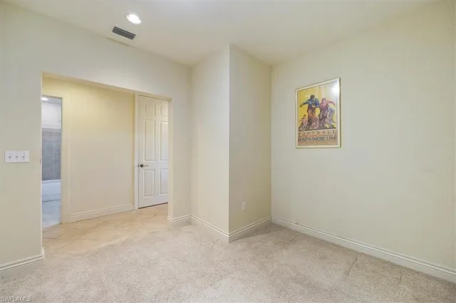 an empty room with a painting on the wall