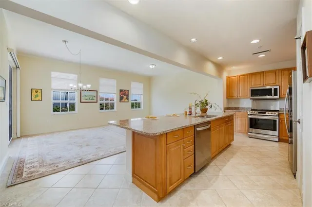 a kitchen with stainless steel appliances granite countertop a refrigerator and a stove top oven
