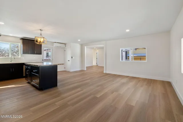 a living room with hard wood floors and furniture or kitchen