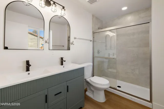 a bathroom with a toilet a sink and a mirror