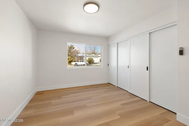a view of a room with wooden floor and window