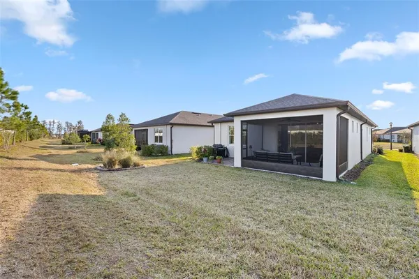 a view of a house with backyard and a garage