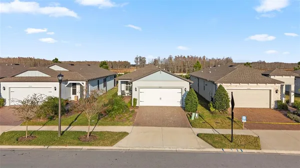 an aerial view of a house with a yard