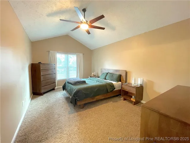 a bed sitting in a bedroom and a chandelier