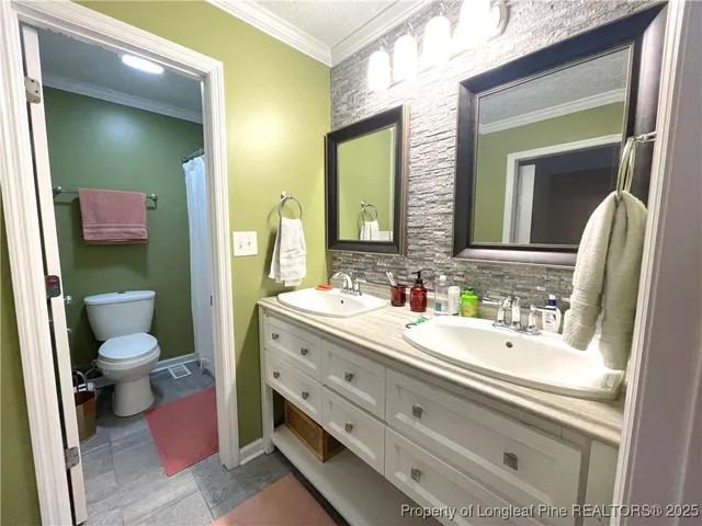 a bathroom with a double vanity sink and mirror