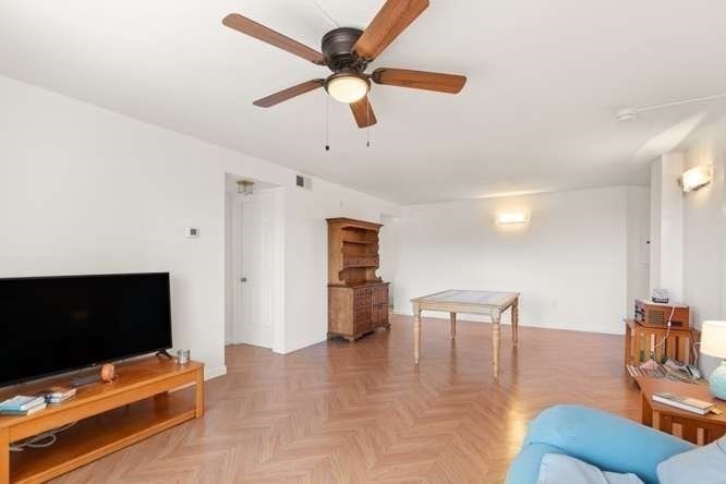 198 Locust Street, Unit 1702 Lynn, MA 01904 - Photo 6 of 26 a living room with furniture and a flat screen tv