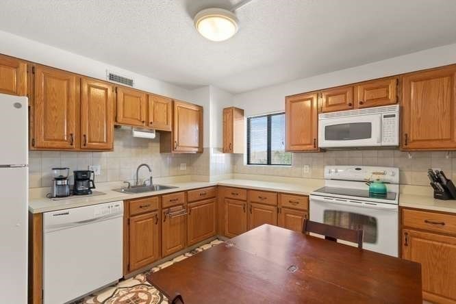 198 Locust Street, Unit 1702 Lynn, MA 01904 - Photo 7 of 26 a kitchen with a sink cabinets and window