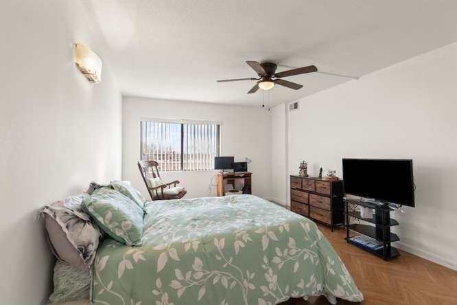 198 Locust Street, Unit 1702 Lynn, MA 01904 - Photo 9 of 26 a spacious bedroom with a bed and a flat screen tv