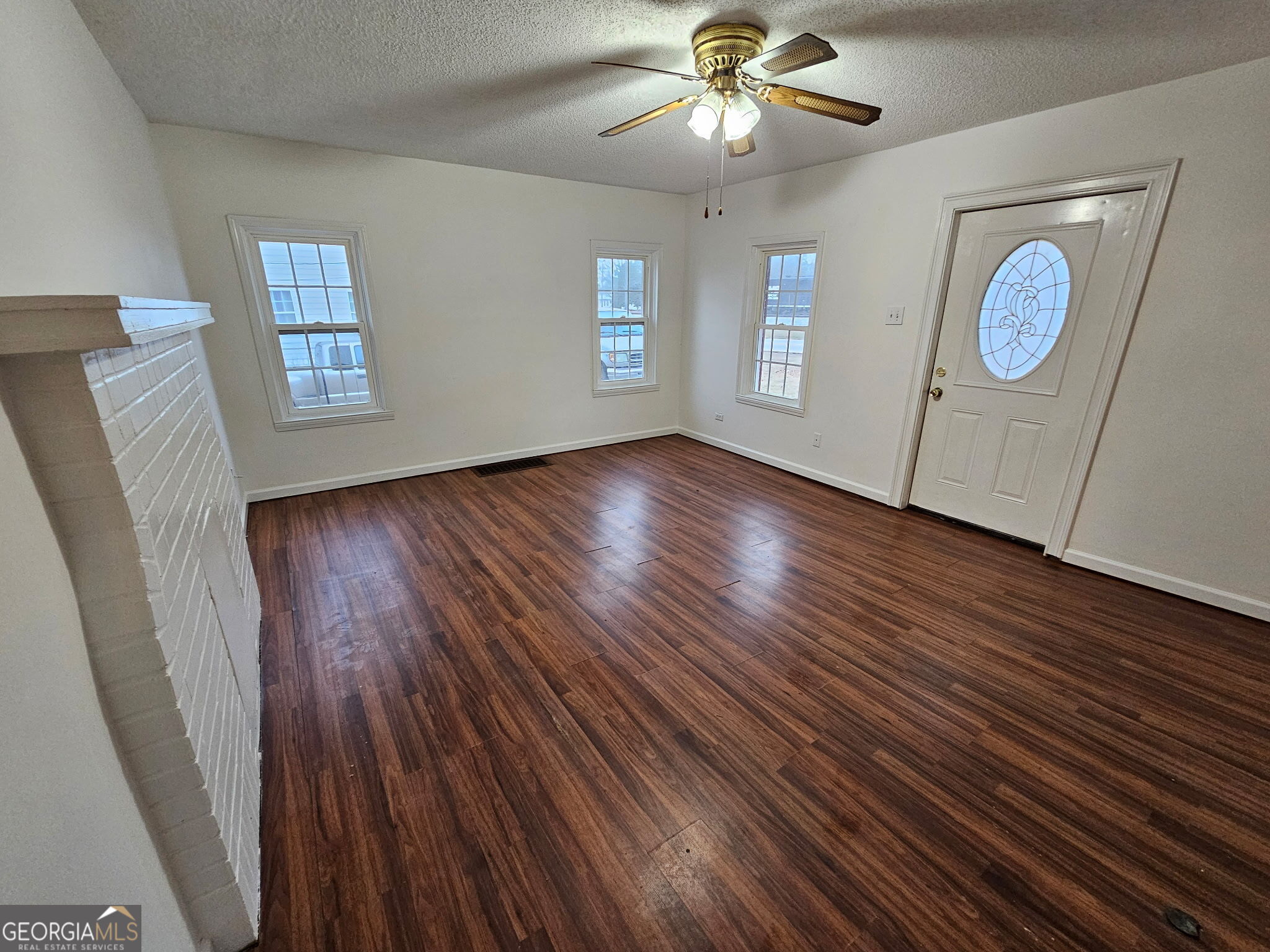 410 Atlantic Avenue Bremen, GA 30110 - Photo 2 of 10 a view of an empty room with wooden floor and a window