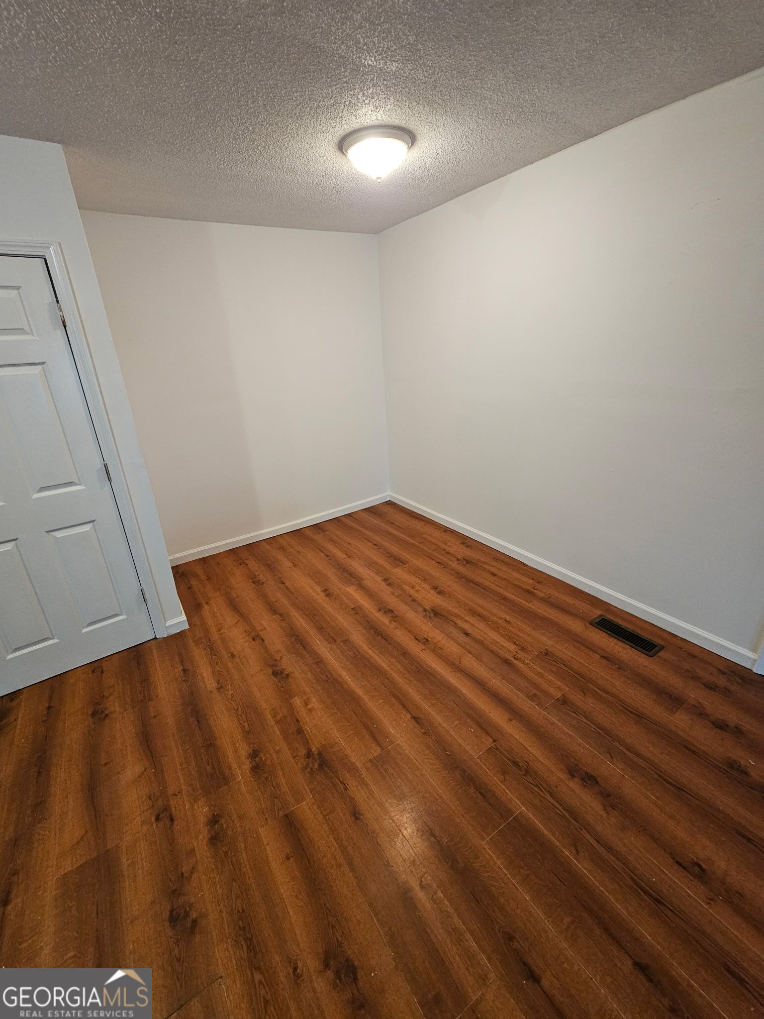 410 Atlantic Avenue Bremen, GA 30110 - Photo 5 of 10 a view of empty room with wooden floor