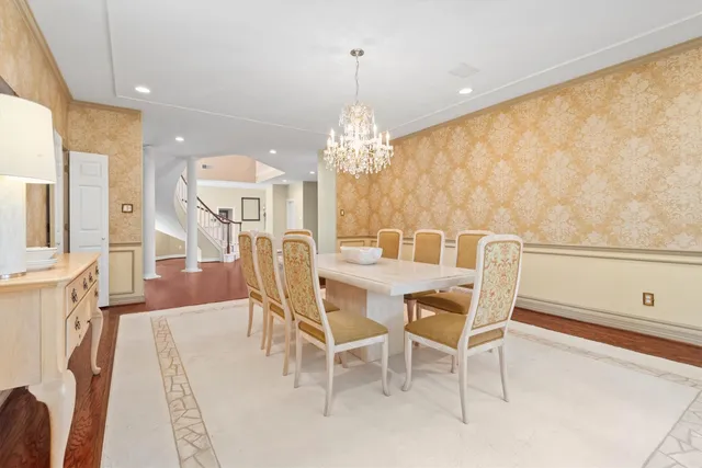 a view of a dining room with furniture and chandelier