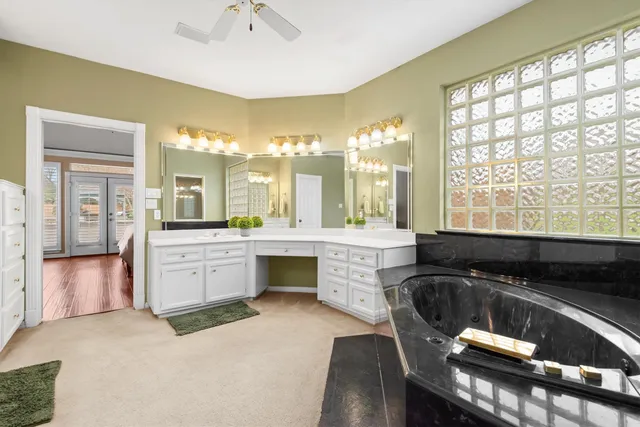 a living room with furniture a rug and a large window