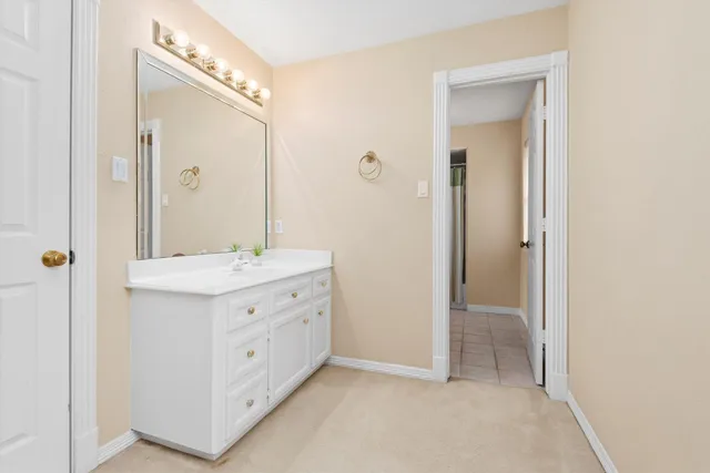 a bathroom with a sink vanity and mirror