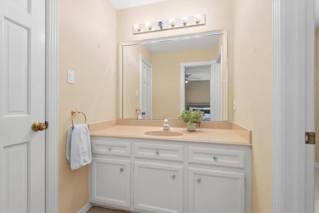 a bathroom with a sink mirror and toilet