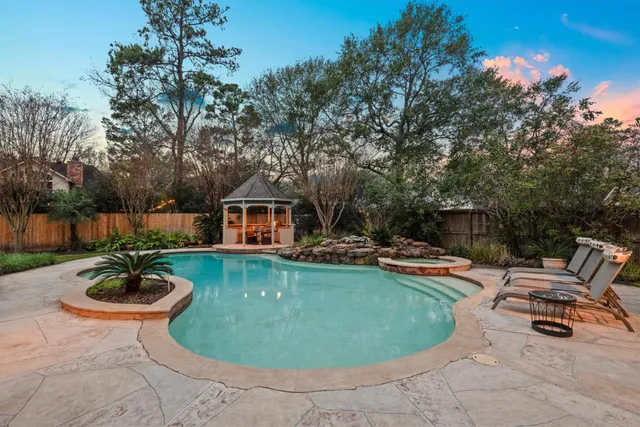a view of a swimming pool and lounge chairs
