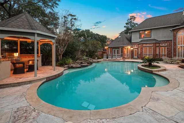 front view of a house with swimming pool and porch