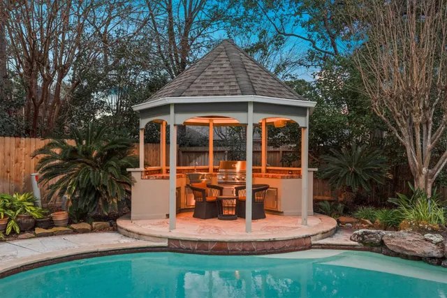 front view of house with a yard and potted plants